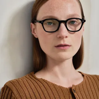 Kat wears Nomos in black acetate with clear optical lenses.