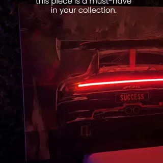 Born to Win V.1 is pure racing energy for your walls. Rear lights glowing red, the car disappearing into the dark, and that license plate SUCCESS as a reminder of why you never slow down. Switch the L